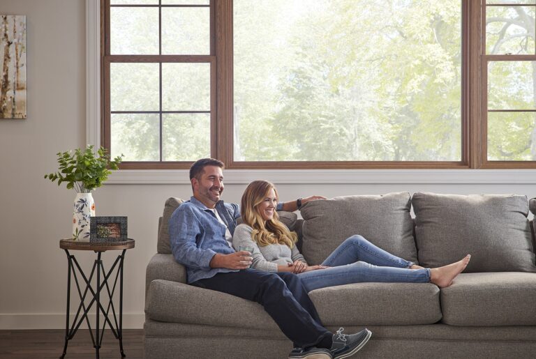 Couple sitting on couch together laughing