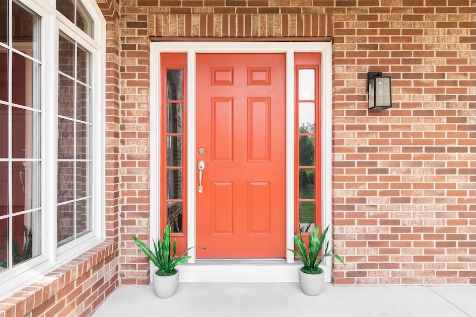 red front door on brick house